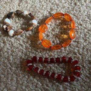 Set of Three Beaded Bracelets in Red, Orange, and Brown